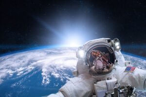 Astronaut in outer space on background of the Earth. Elements of this image furnished by NASA.